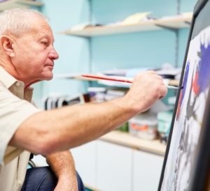 Elderly man painting