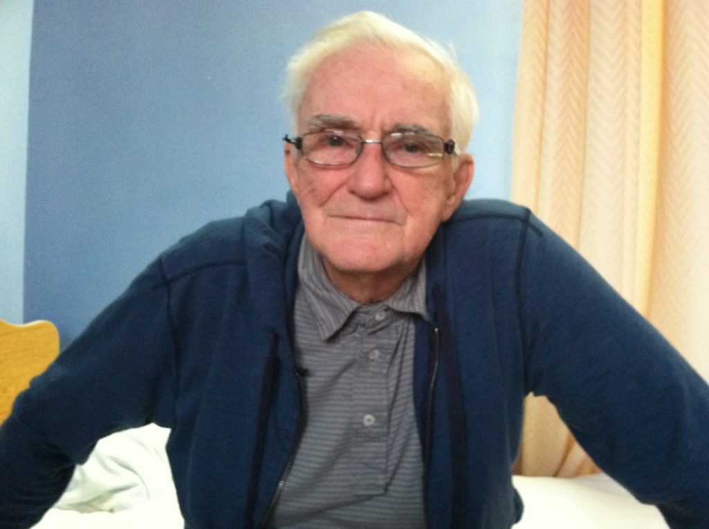 Robert Pontius elderly, sitting on bed