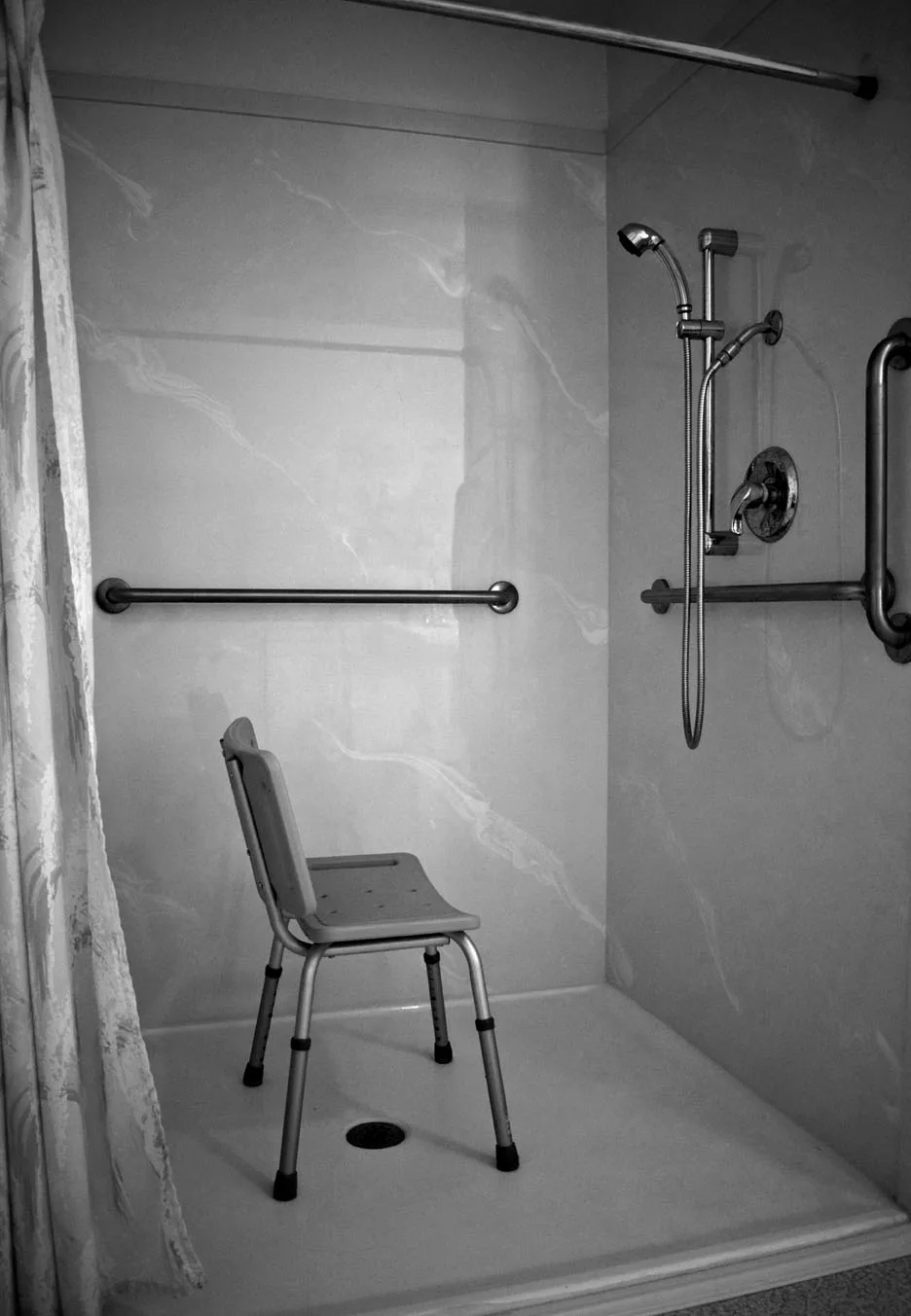 Photo of empty shower chair in the walk-in shower. Katie Benson