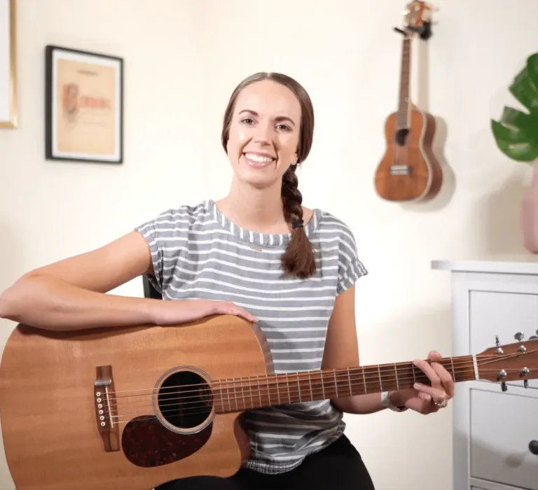 Alexis Baker holding a guitar