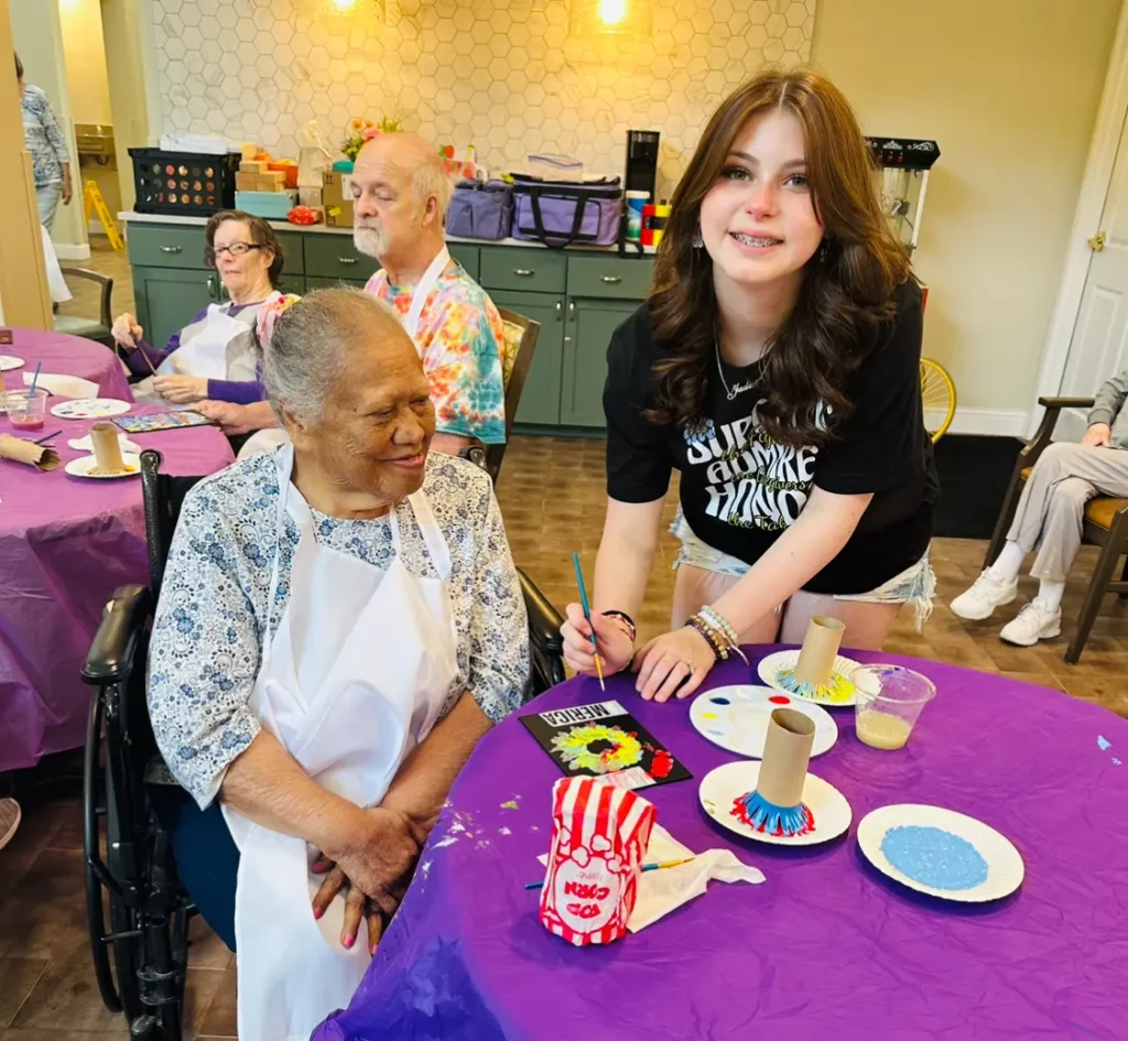 Roselyn with resident painting