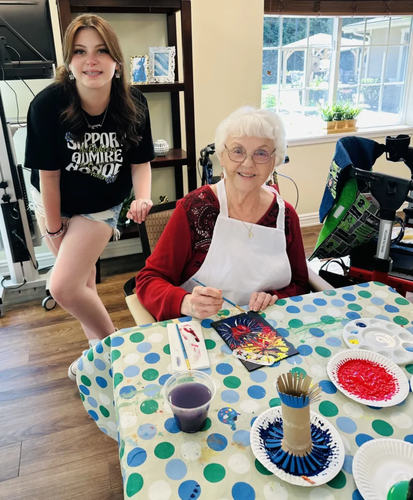 Roselyn with resident painting