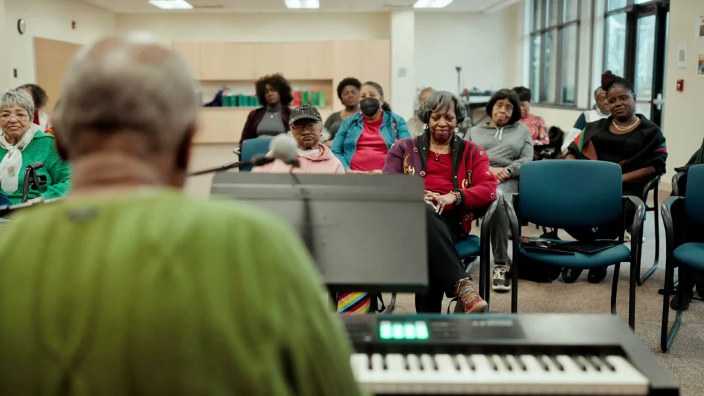 Grant West plays the piano to the Amazing Grace dementia-friendly gospel chorus. 