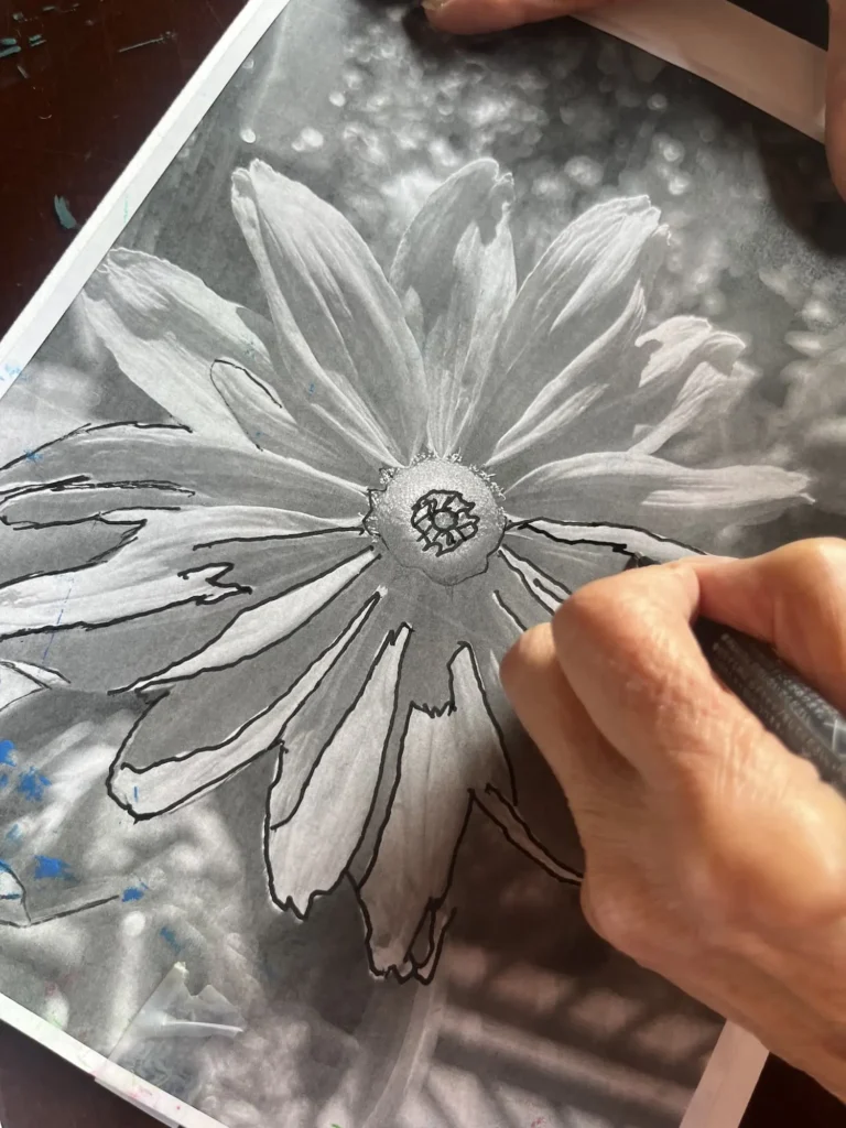 Person outlining a flower