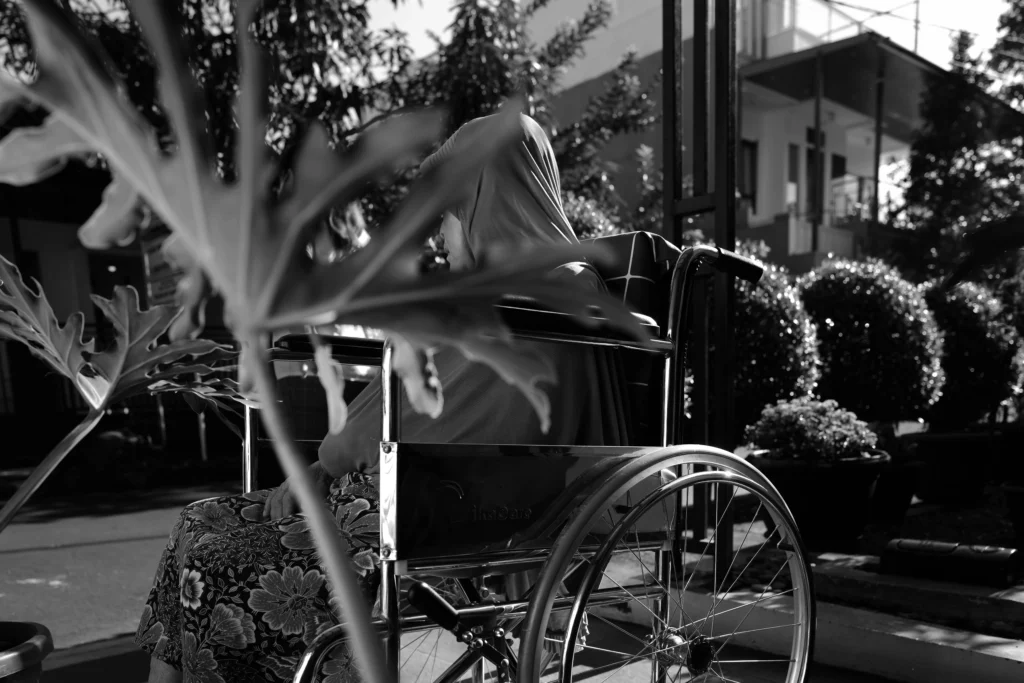 E. Holi enjoys a sun bath in the morning from her wheelchair.