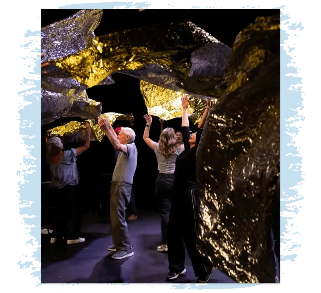 Participants move as one beneath a canopy of gold, symbolizing connection, creativity and shared imagination at the heart of Goldspun.