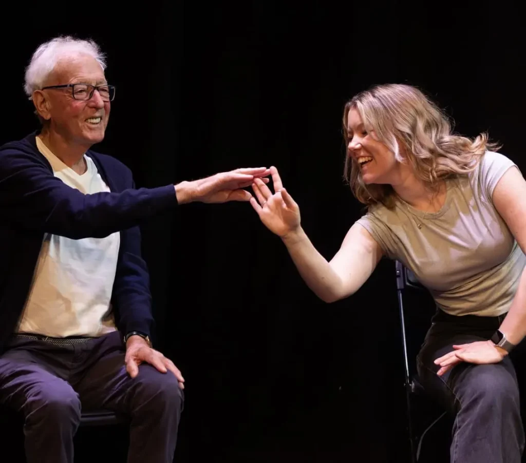 A shared gesture becomes a dance of trust and friendship—an image of how Goldspun weaves human connection into art.