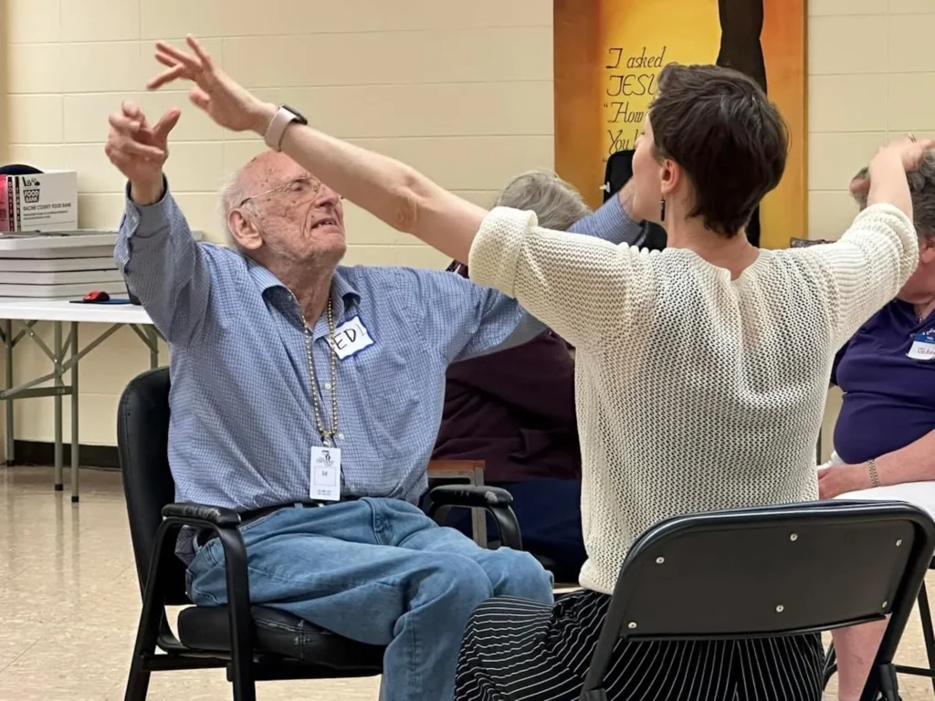 Man and woman seated dancing to music