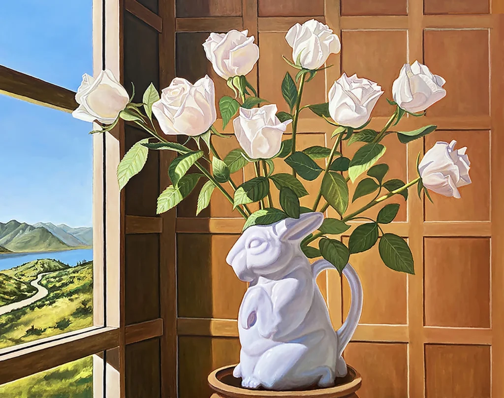 White roses in a porcelain rabbit vase facing a window that opens into a green pasture.