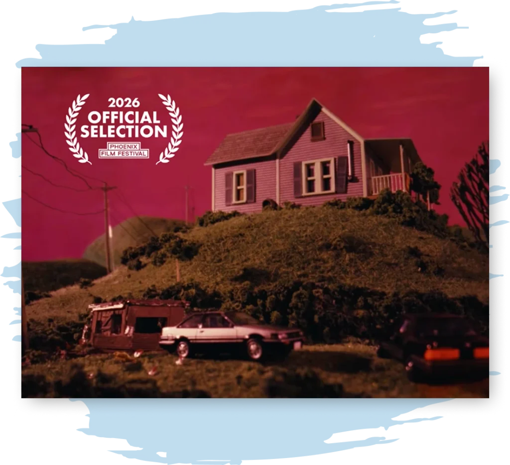 A diorama of a toy house on a hill with a dark red sky.