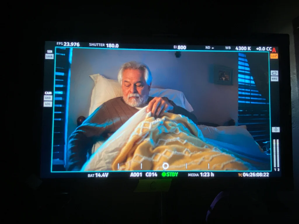 A scene from film production of a man getting out of bed