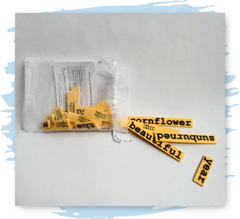 Words on bright yellow strips fall out of a small drawstring bag