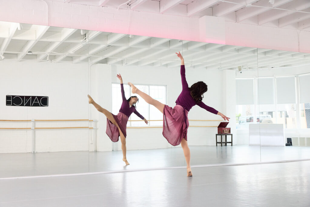 A woman practices ballet in a studio