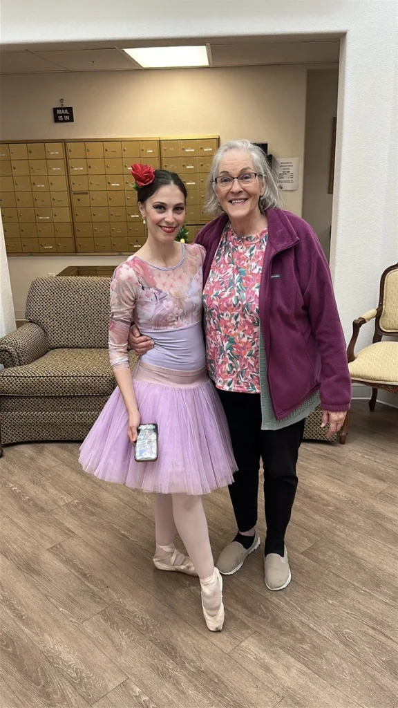 Emily Ricca stands next to a senior facility staff member